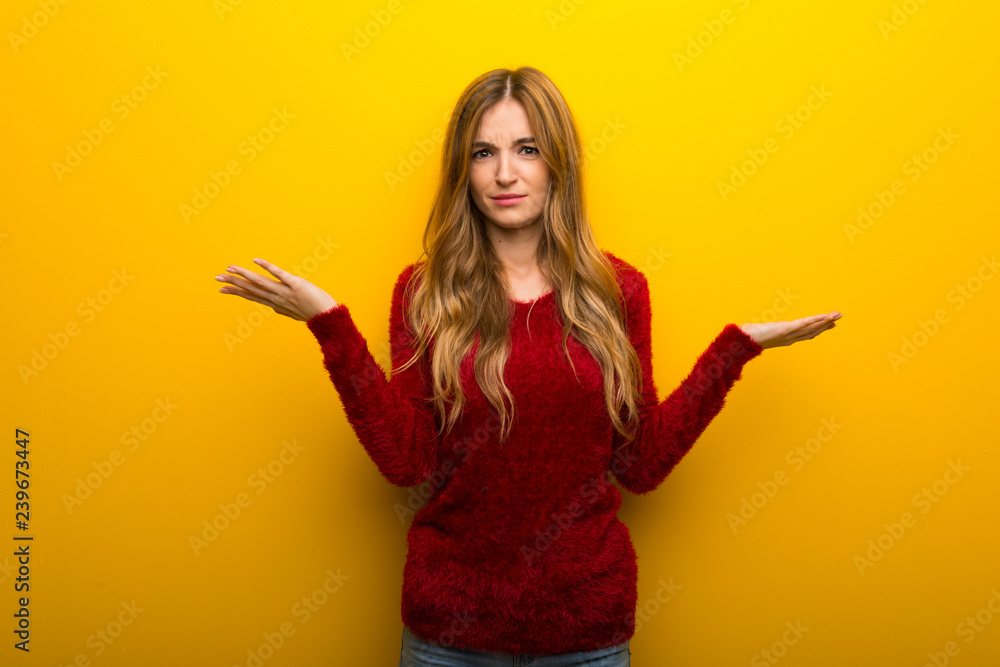 Young girl on vibrant yellow background unhappy and frustrated with something because not understand something Young girl on vibrant yellow background unhappy and frustrated with something because not understand something