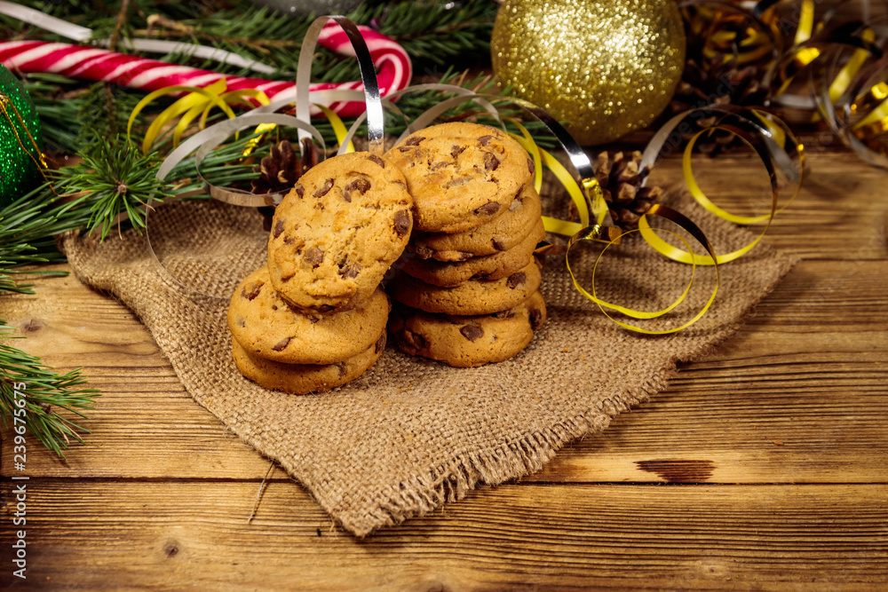 Chocolate chip cookies with Christmas decoration on wooden table Chocolate chip cookies with Christmas decoration on wooden table