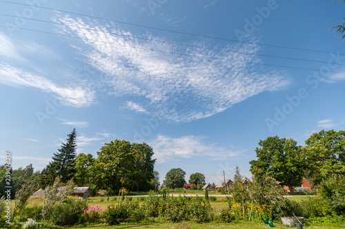 high contrast clouds on blue sky over natural landscape