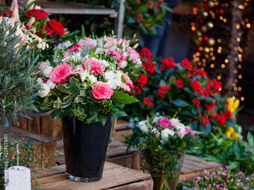 View of a bouquet of scarlet roses in a street flower shop in Paris  France.