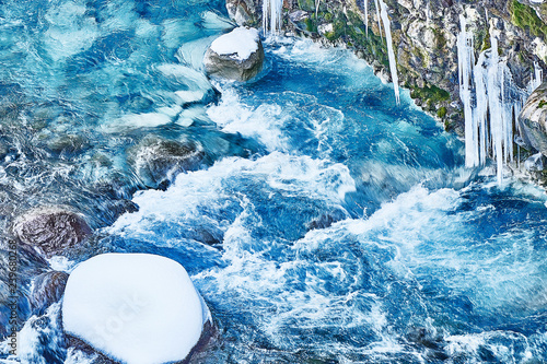 Mysterious blue, bearded waterfall and beautiful snow covering the whole world photo