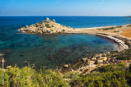 Small Alagadi beach panorama with peninsula and dry pasture photo