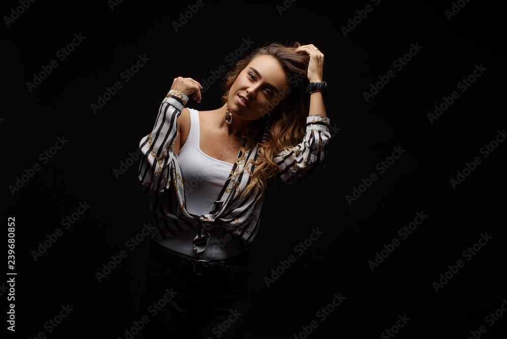 Portrait with copy space empty place of cheerful laughter funny comic girl having flying hair on black background, enjoying wind flow. Dancing for win on lottery Portrait with copy space empty place of cheerful laughter funny comic girl having flying hair on black background, enjoying wind flow. Dancing for win on lottery