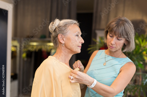 Wallpaper Mural Shop assistant helping senior woman in a boutique Torontodigital.ca