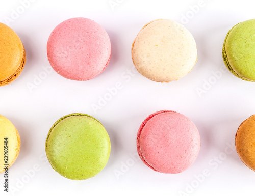 Top view of two rows of French macarons isolated on white - closeup