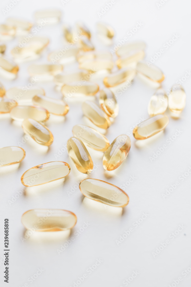 Pile of scattered capsules with medication on white background Pile of scattered capsules with medication on white background