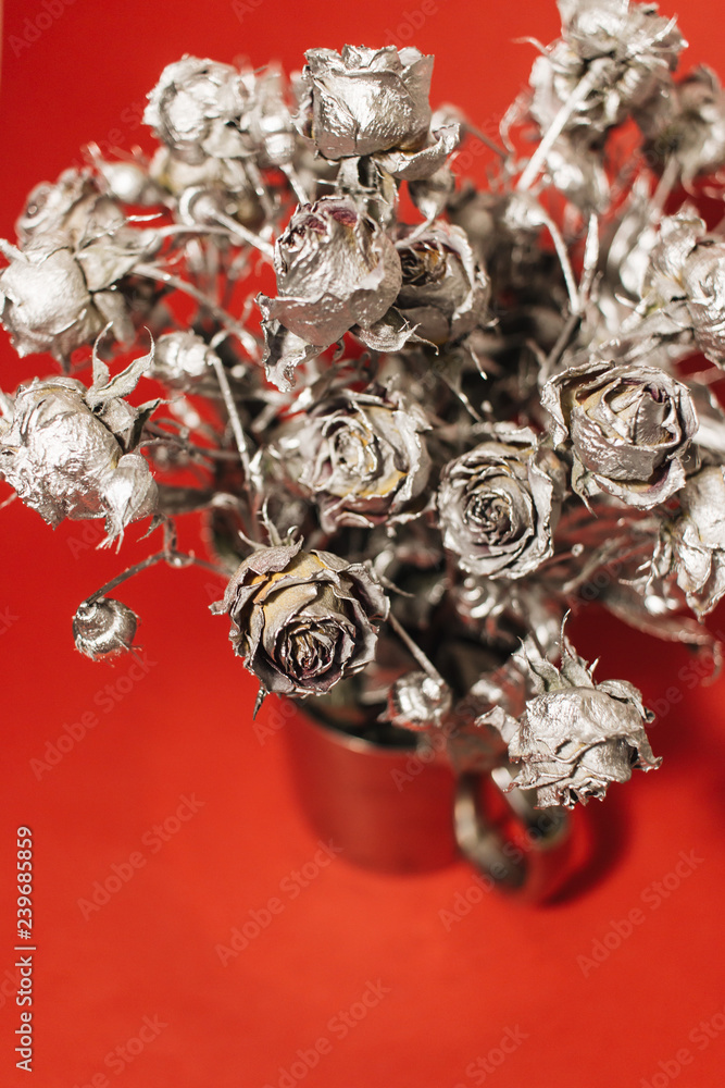 Christmas decoration with silver roses on red background Christmas decoration with silver roses on red background