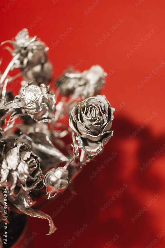 Christmas decoration with silver roses on red background Christmas decoration with silver roses on red background