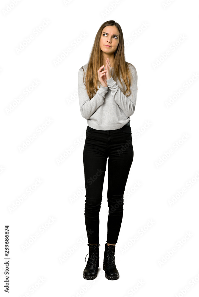 Full-length shot of young girl scheming something on isolated white background Full-length shot of young girl scheming something on isolated white background