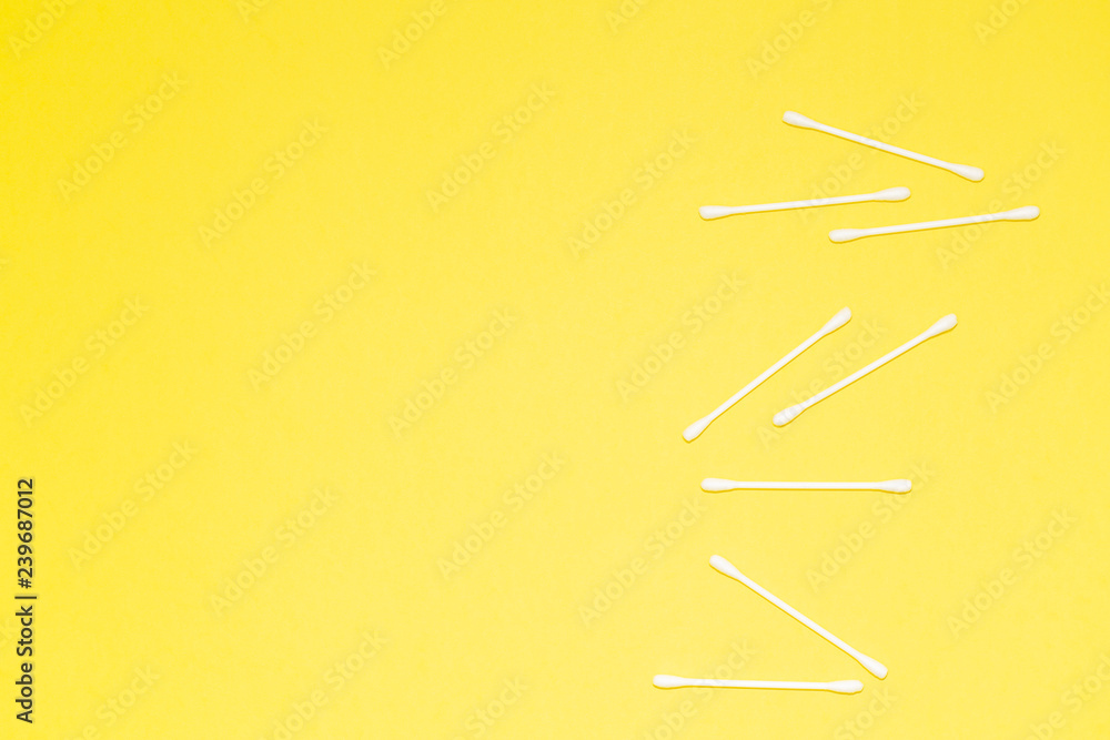Fototapeta premium Cotton buds isolated on yellow background, plastic cotton swabs