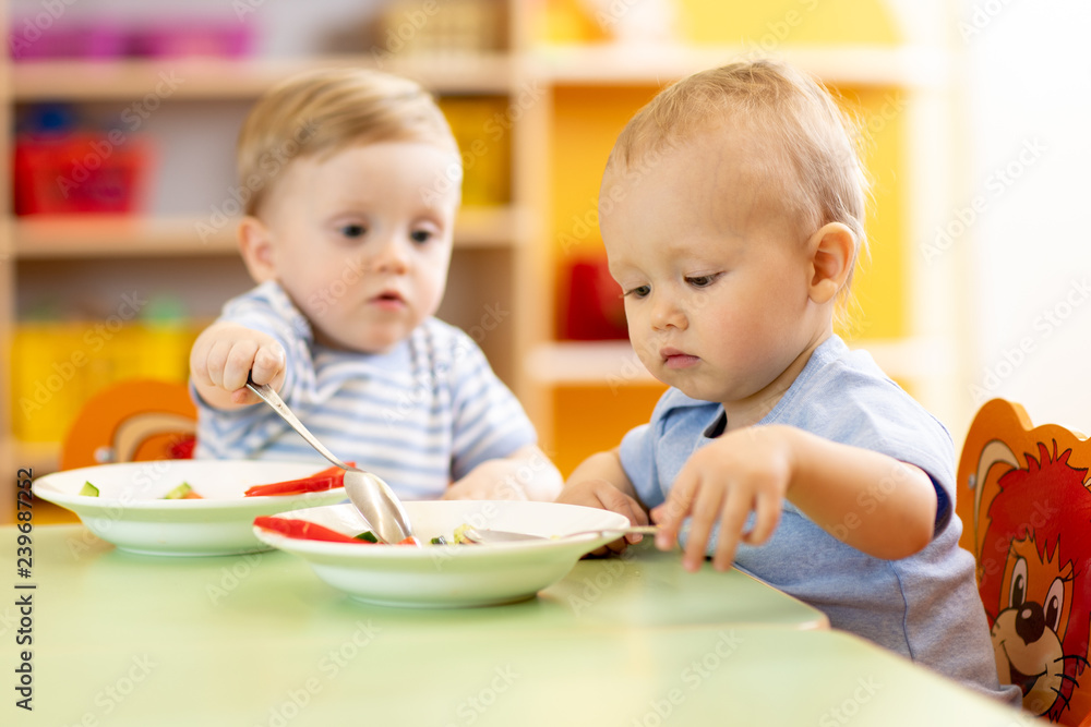 babies children eating healthy food in nursery or kindergarten babies children eating healthy food in nursery or kindergarten
