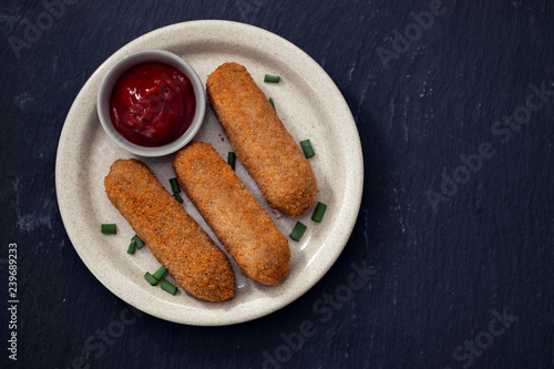 meat croquets with sauce on dish photo