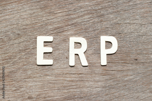 Alphabet letter in word ERP (Abbreviation of Enterprise Resource Planning) on wood background