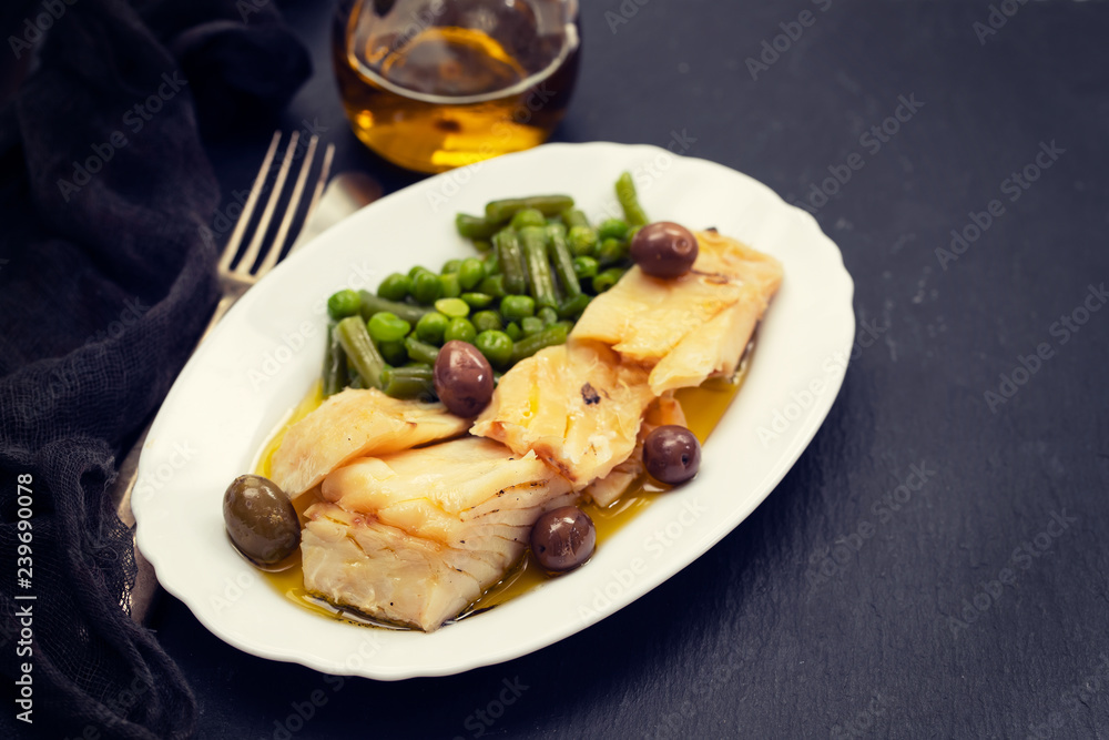 fried cod fish with peas and green beans on white dish fried cod fish with peas and green beans on white dish