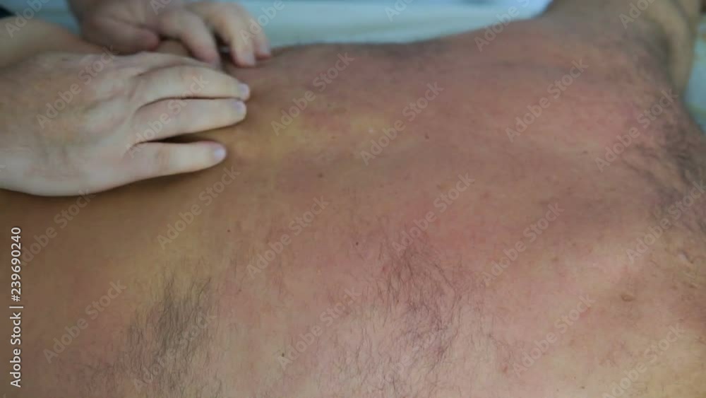 Professional masseur makes massage for old man Professional masseur makes massage for old man