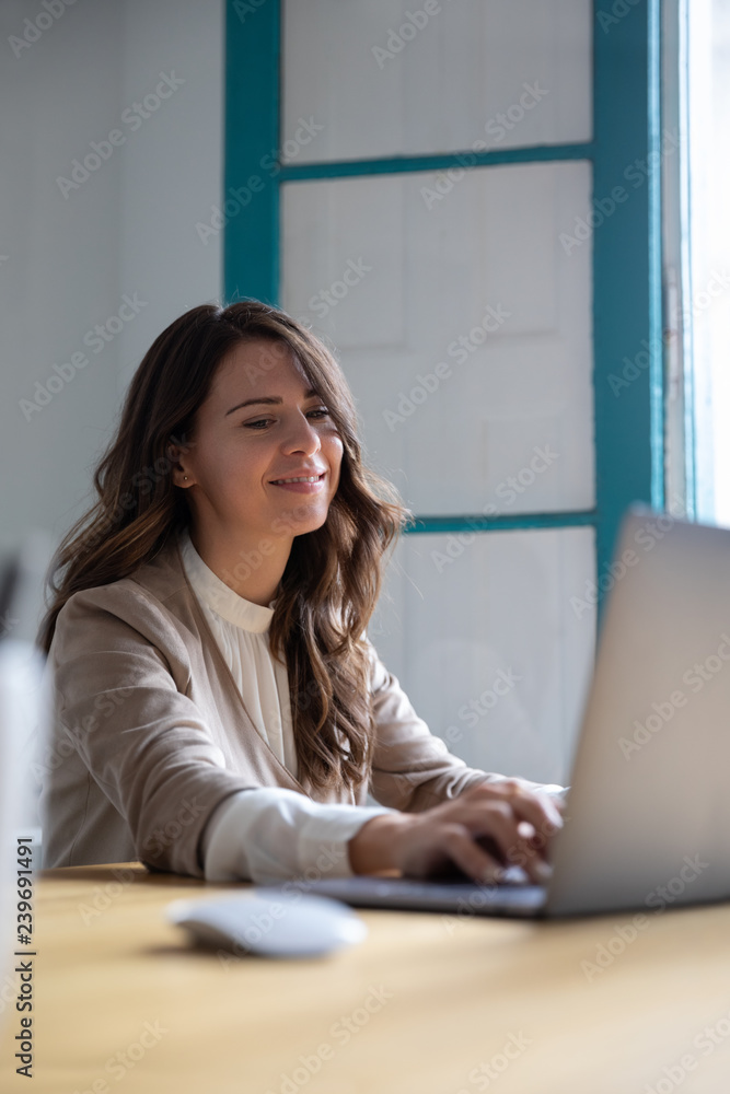 Young woman working with her laptop at home Young woman working with her laptop at home