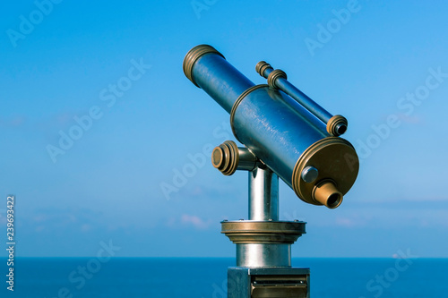 Amazing view of metallic telescope in front of the sea and blue sky- Image