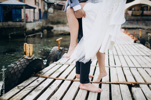 Bride and groom legs on wooden floor