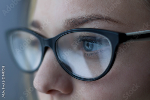Wallpaper Mural Close-up shot of woman eyes in glasses reflecting a working computer Torontodigital.ca