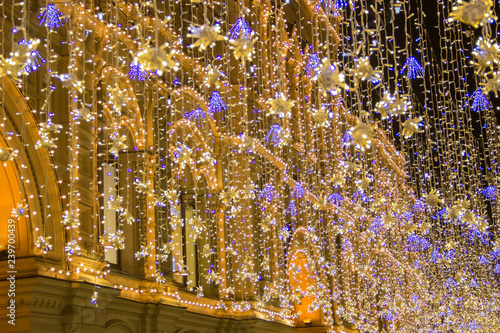 Magic lights garland illumination on christmas holidays in central Moscow area in the evening. Bottom view