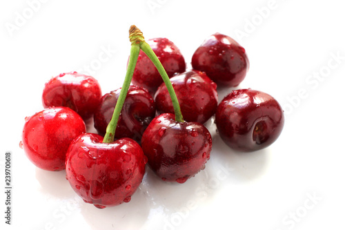 Fresh ripe red cherries lie on a white background