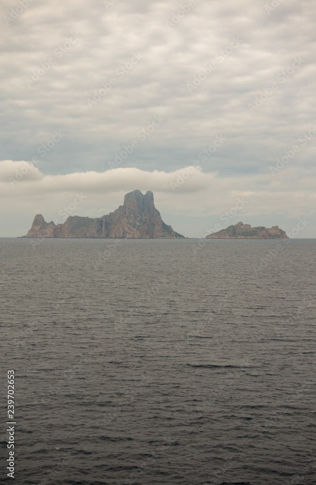 The island of es vedra from behind from a boat