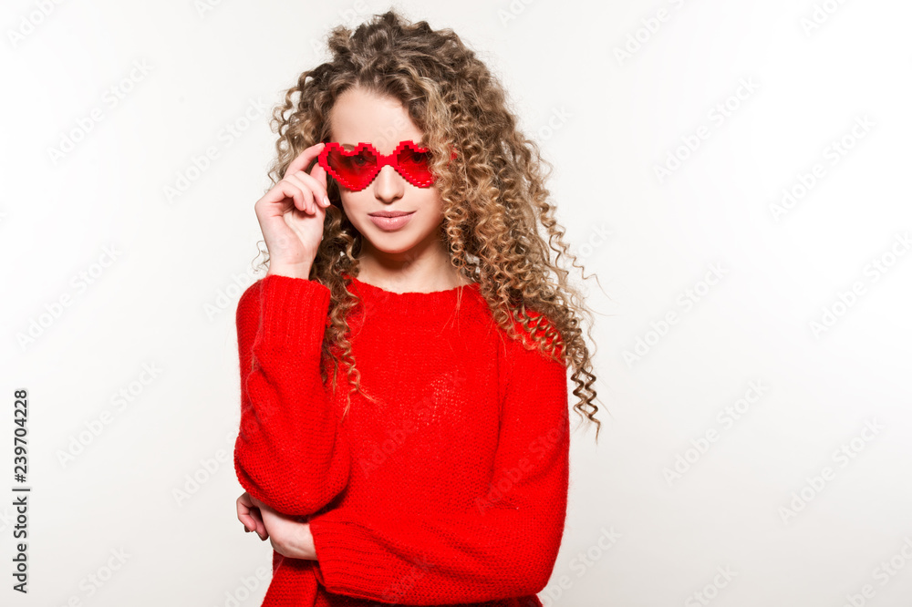 Valentine's Day. Beautiful girl in red sweater with glasses hearts.
Valentine's Day. Beautiful girl in red sweater with glasses hearts.