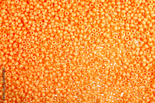 Flame-orange glass beads background - closeup beads texture