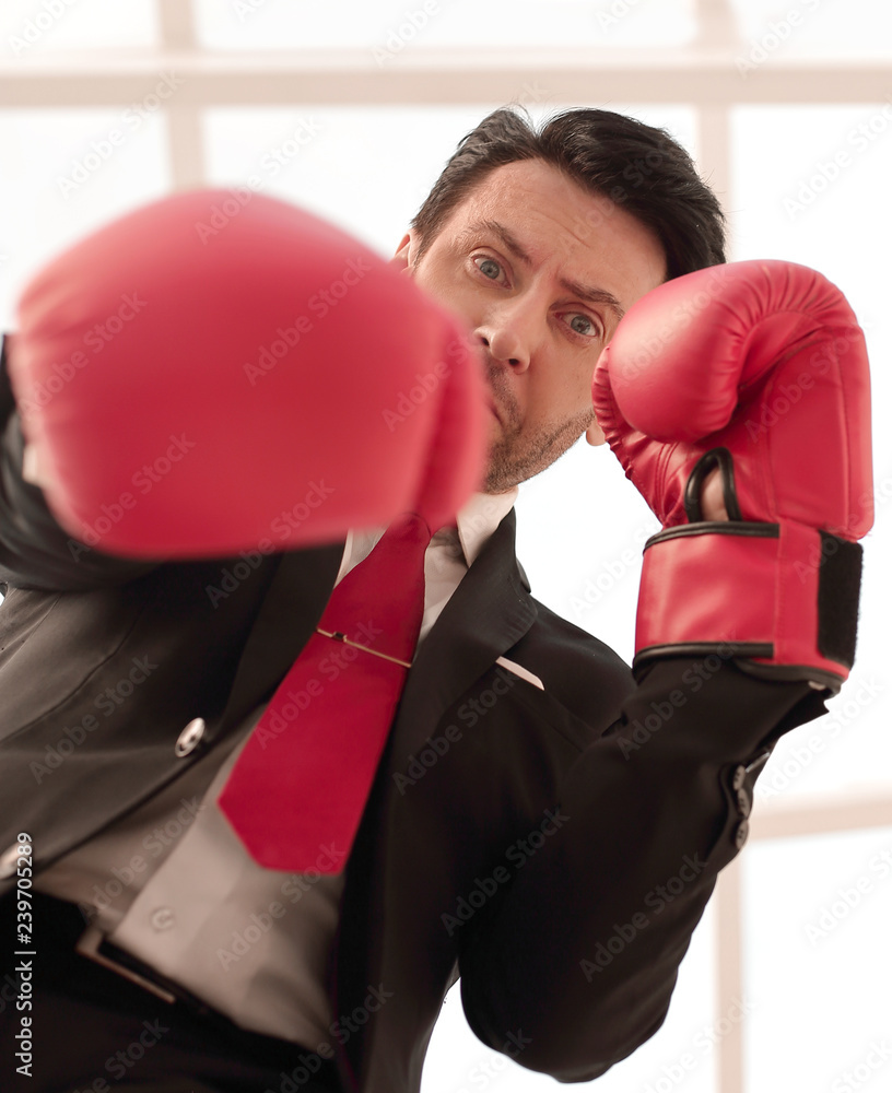 close up.a serious businessman in red Boxing gloves close up.a serious businessman in red Boxing gloves