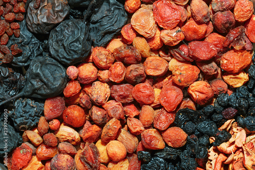 Healthy food. Background of dried fruit. Rows of dried apricots, pears, raisins, apples, prunes Healthy food. Background of dried fruit. Rows of dried apricots, pears, raisins, apples, prunes