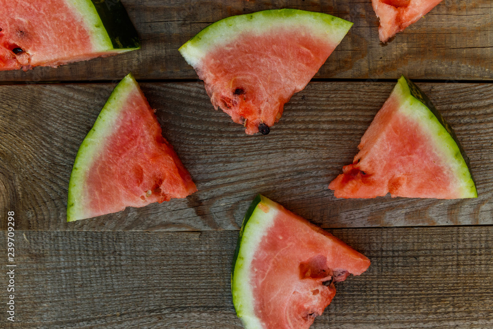 Fresh ripe sliced watermelon on rustic wooden table