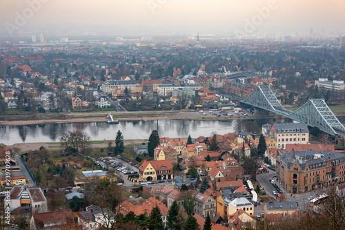 View from the height to the Elbe with the blue wonder, an old steel girder bridge, at the edge, the residential development of Loschwitz in the foreground and the old town in the background