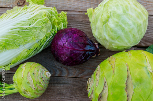 Several kinds of cabbage on rustic wooden table. Top view