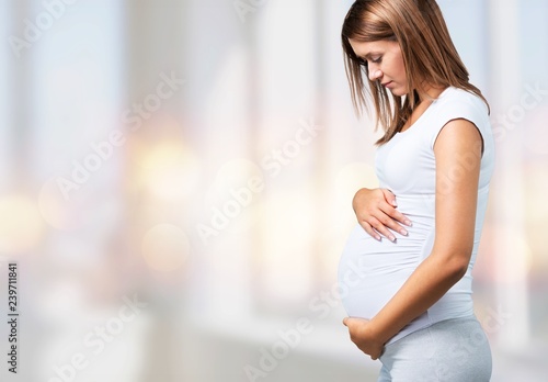 Pregnant young woman in white t shirt on background Free Download Pregnant young woman in white t shirt on background - GFXLoad