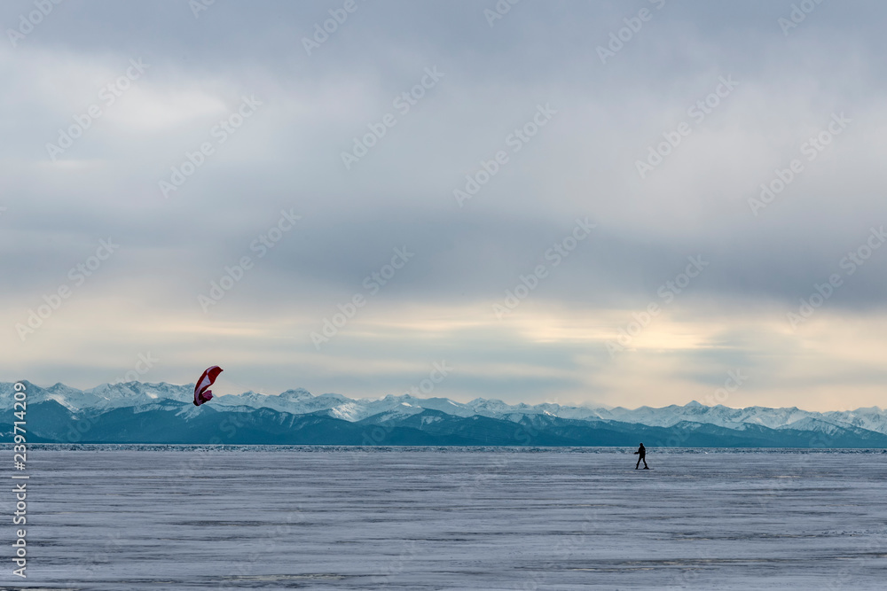 man kiting on the ice of lake Baikal