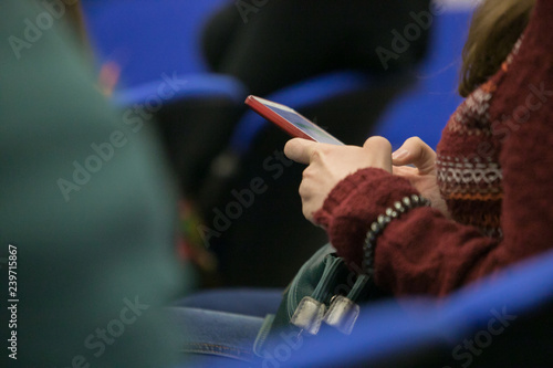 Closeup of human hand writing at a conference.