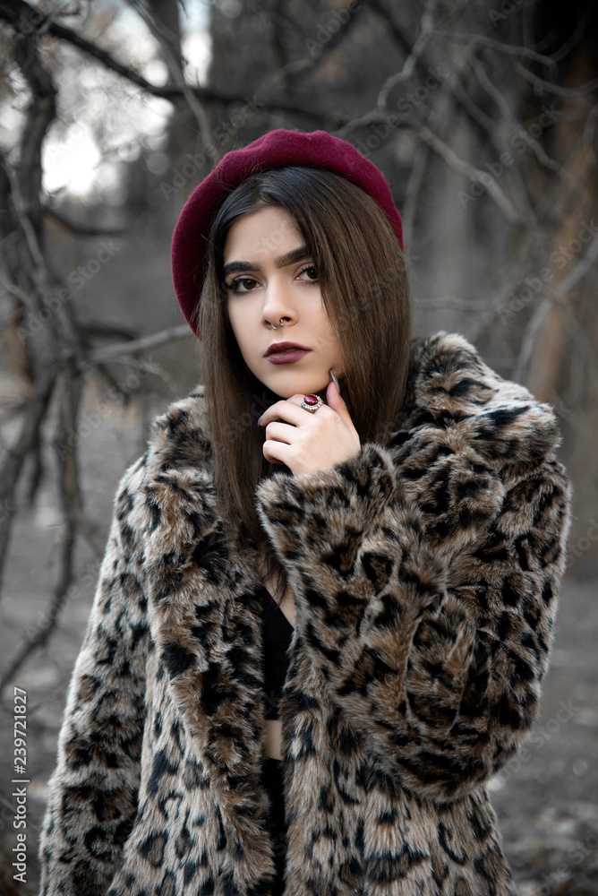 Young woman wearing fur coat and beret outdoors Young woman wearing fur coat and beret outdoors