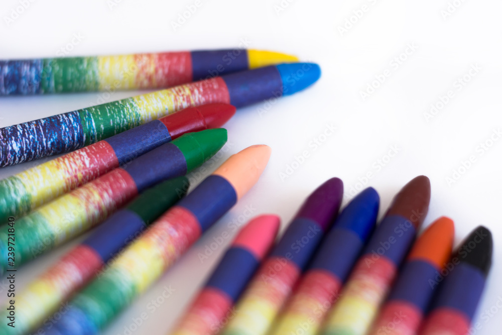 Colored wax pencils on a white background close-up Colored wax pencils on a white background close-up