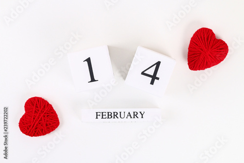Red homemade diy heart made cardboard, yarn, wooden perpetual calendar on white background. Idea St. Valentines Day, day love, February 14 concept. Copy space, top view, flat lay composition.