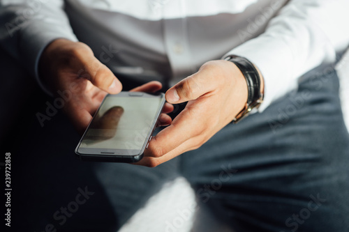 Mock up of a man holding device and touching screen. Clipping path