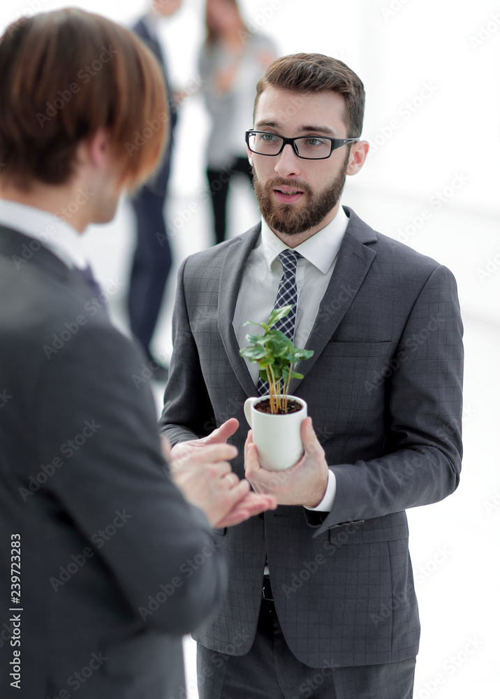 successful young businessman with young sprout successful young businessman with young sprout