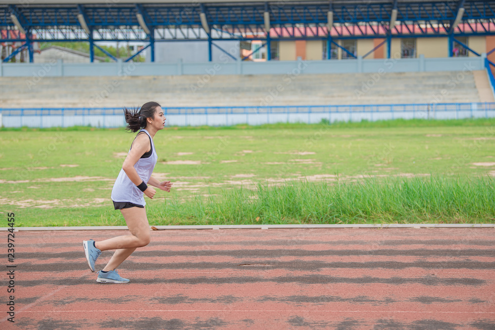 Asian beautiful woman running on the track,Thailand people,The runners run training for the competition.
