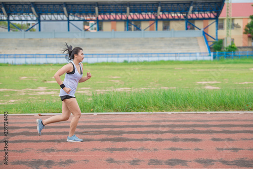 Asian beautiful woman running on the track,Thailand people,The runners run training for the competition.