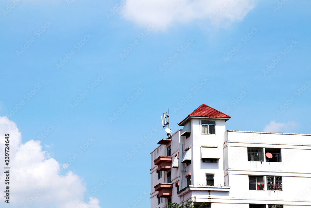white old apartment thai style, condominium, accommodation on sky blue background view in thailand