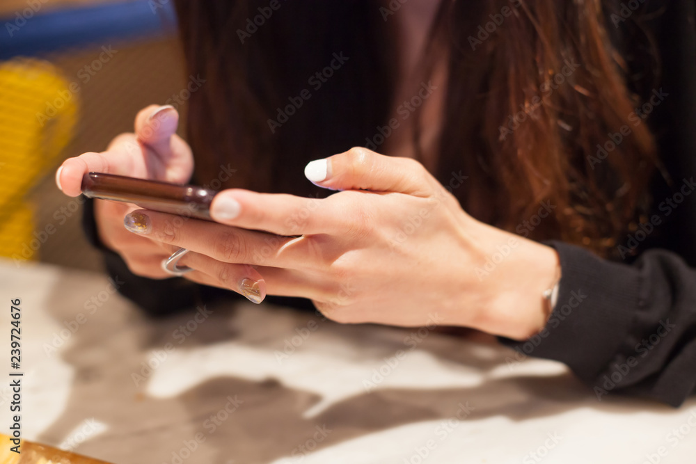 Woman using smart mobile phone on the table, Shopping and Communicating with digital technology. Modern Trend, Lifestyle, Business Transaction, Communication, Artificial Society and Mobile App concept