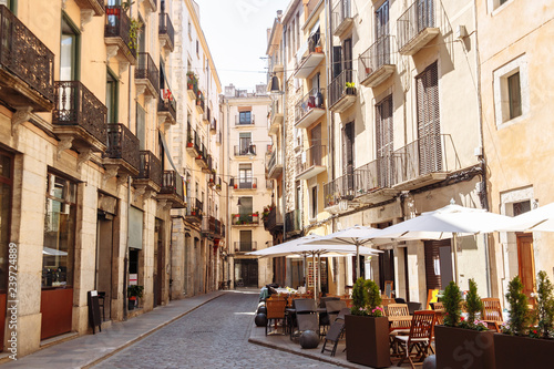 Street view with cafes in the old town in Girona city
