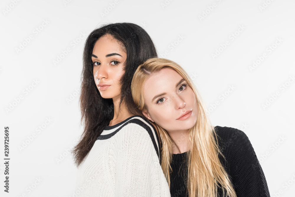 beautiful caucasian woman leaning on shoulder of african american girl and they looking at camera isolated on white beautiful caucasian woman leaning on shoulder of african american girl and they looking at camera isolated on white
