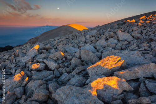 Moon and sunrise at the Mount Acquaviva in the amphitheater of the Murelle, Majella national park, Abruzzo, Italy, Europe photo