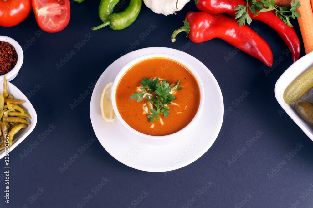 Tomato soup bowls on dark background. Top view. Copy space. Tomato soup bowls on dark background. Top view. Copy space.