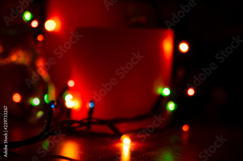 Christmas candles with glowing illumination garland. New Year winter home decoration theme. For this photo applied blurring effect.